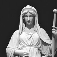 Vesta depicted in classical statue art as the serene goddess of hearth, home, and sacred fire.